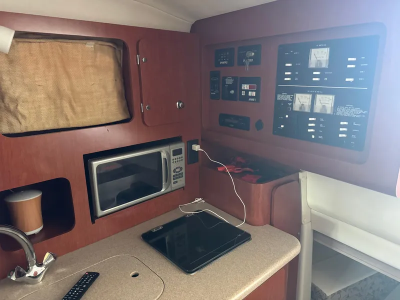 Slide: The Image of 2006 Pro-Line 32 Express cabin interior with microwave, control panels, and countertop. - 22