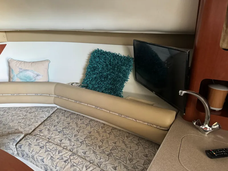 Slide: The Image of Interior of 2006 Pro-Line 32 Express boat with cozy seating and TV. - 23