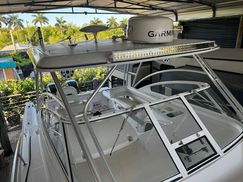 Slide: The Image of 2006 Pro-Line 32 Express boat with Garmin equipment, docked under a canopy. - 26