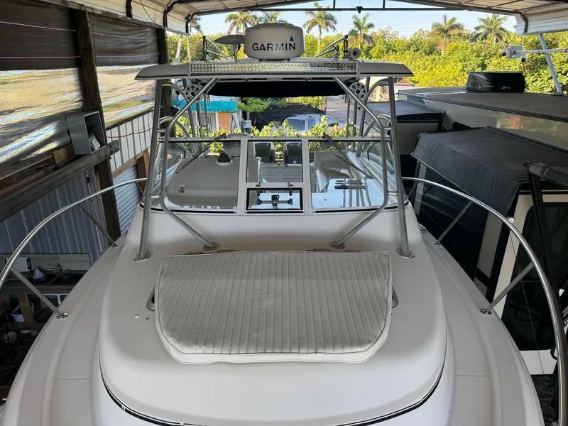 Slide: The Image of 2006 Pro-Line 32 Express boat with Garmin equipment, docked under a canopy. - 28