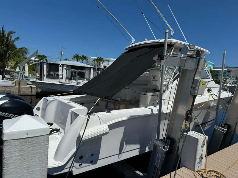 Slide: The Image of 2006 Pro-Line 32 Express boat docked under clear blue sky. - 3