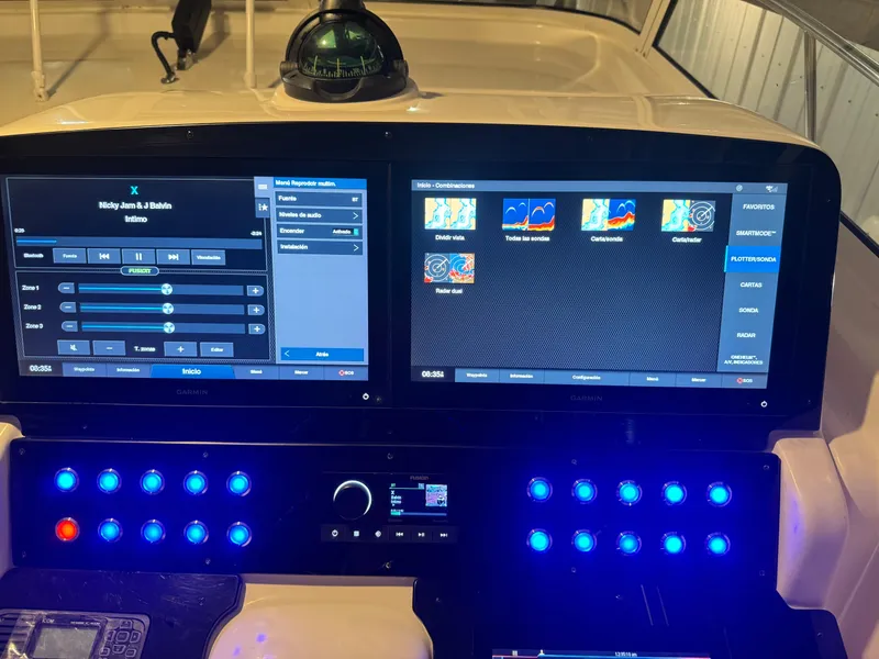 Slide: The Image of 2006 Pro-Line 32 Express boat dashboard with dual screens and illuminated controls. - 30