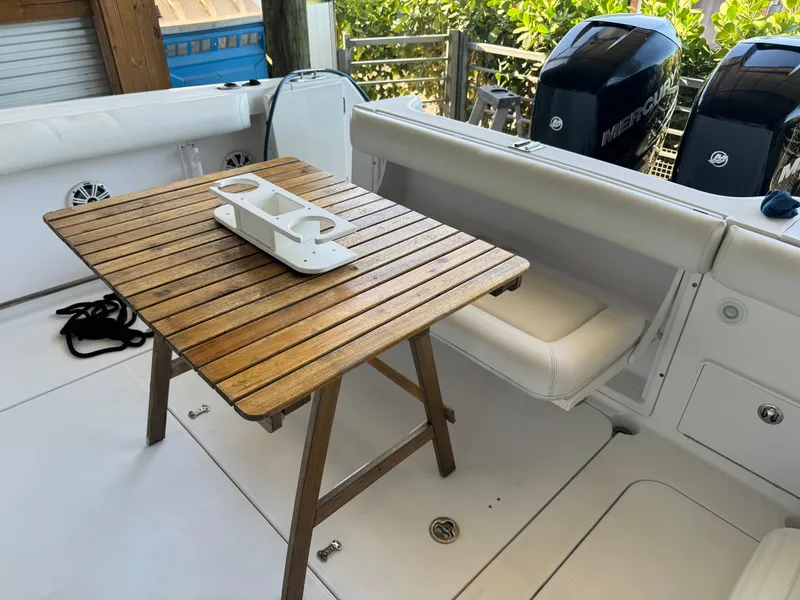 Slide: The Image of 2006 Pro-Line 32 Express boat interior with wooden table and seating. - 4