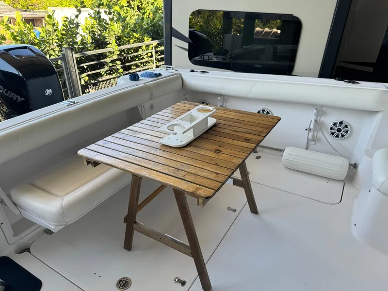 Slide: The Image of 2006 Pro-Line 32 Express boat interior with wooden table and cushioned seating. - 5