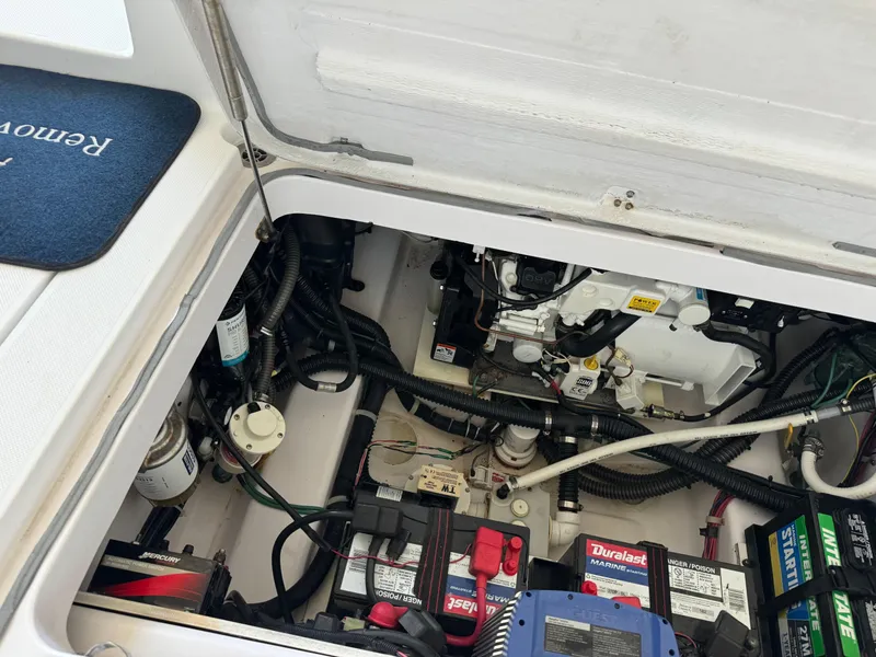 Slide: The Image of Engine compartment of 2006 Pro-Line 32 Express boat with visible batteries and wiring. - 6