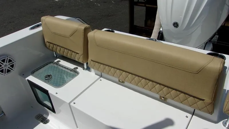 Slide: The Image of 2025 Sportsman Heritage 231 CC boat interior with tan cushioned seating. - 10