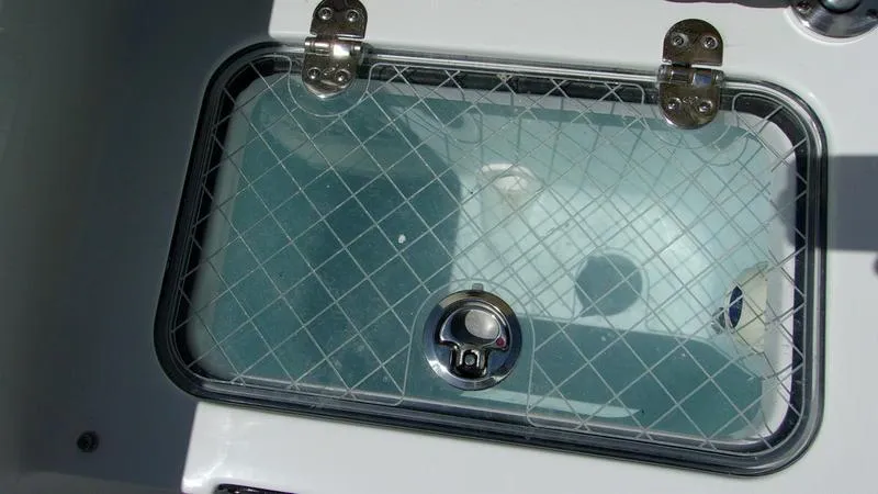 Slide: The Image of Livewell on 2025 Sportsman Heritage 231 CC boat with transparent lid and latch. - 11