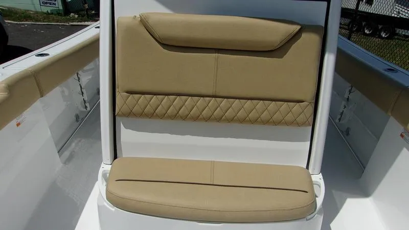 Slide: The Image of 2025 Sportsman Heritage 231 CC boat seat with tan upholstery and diamond stitching. - 15