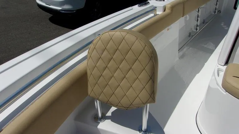 Slide: The Image of 2025 Sportsman Heritage 231 CC boat seat with diamond-patterned upholstery. - 16