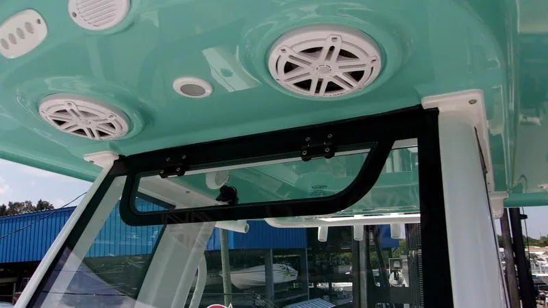 Slide: The Image of 2025 Sportsman Heritage 231 CC boat interior with speakers and teal ceiling. - 17