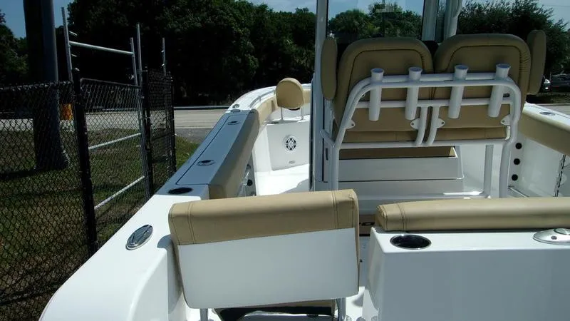 Slide: The Image of 2025 Sportsman Heritage 231 CC boat interior with tan seating and rod holders. - 7