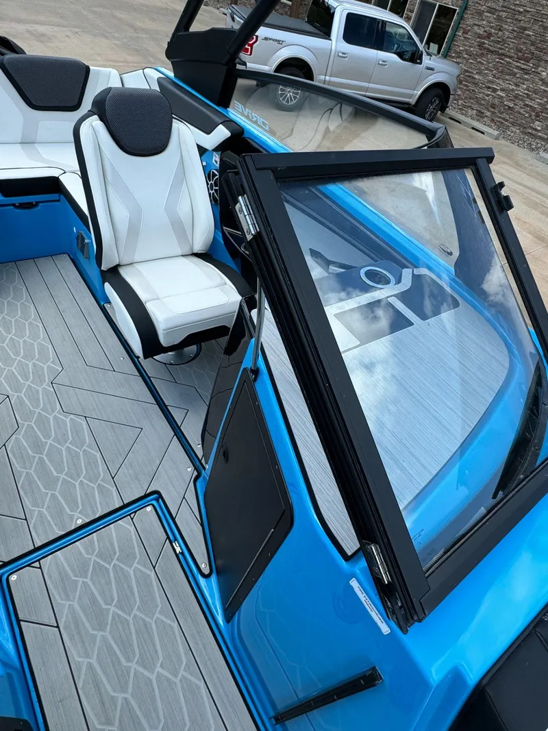 Slide: The Image of 2023 Yamaha Boats 222XD interior with white seating and blue accents. - 11