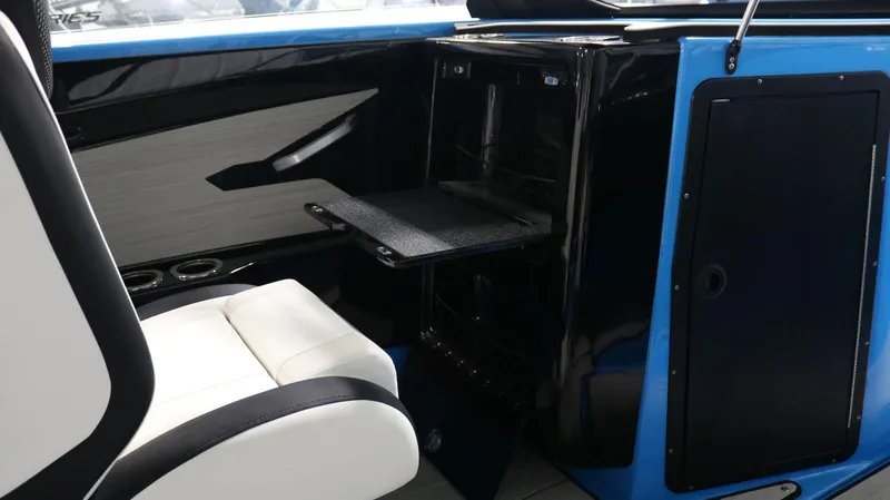 Slide: The Image of 2023 Yamaha Boats 222XD interior with white seating and black storage compartment. - 12