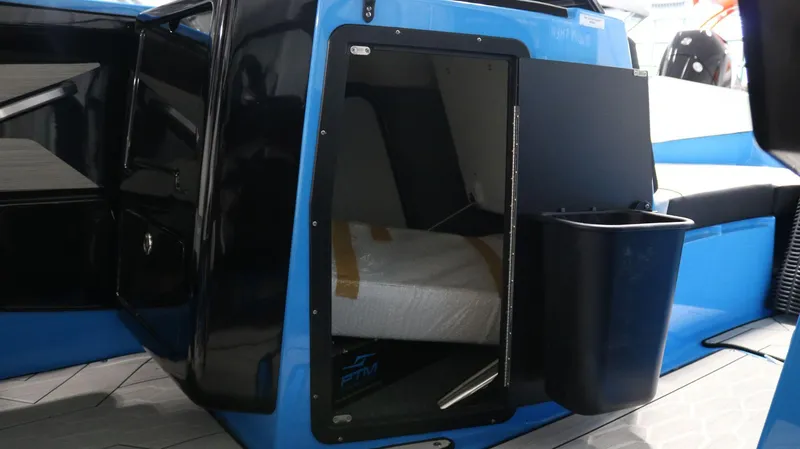 Slide: The Image of 2023 Yamaha Boats 222XD interior cabin with blue and black design. - 13
