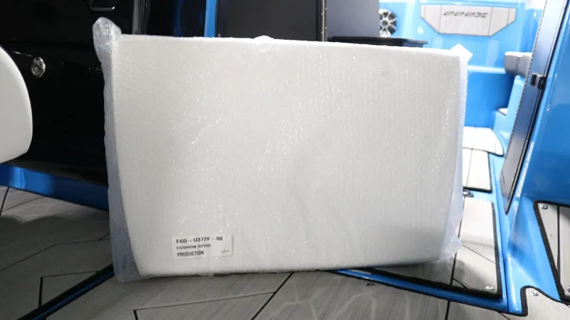 Slide: The Image of Packaged cushion inside 2023 Yamaha Boats 222XD, featuring blue interior and modern design. - 14
