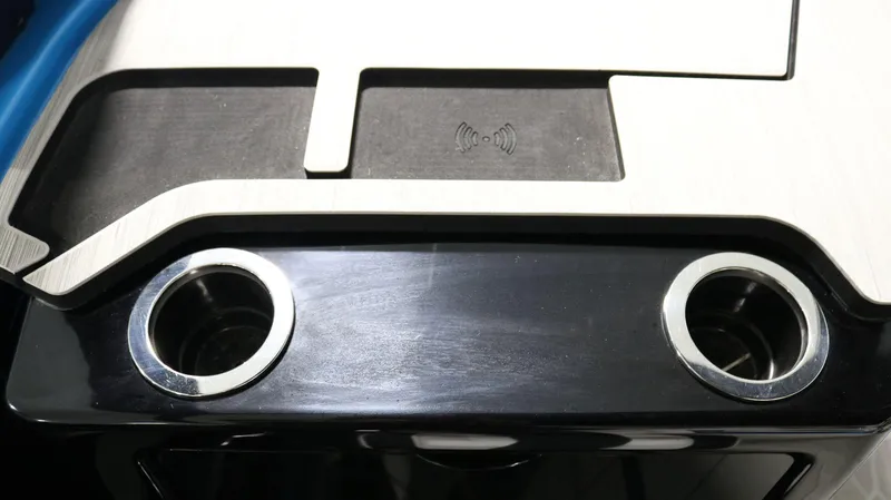 Slide: The Image of 2023 Yamaha Boats 222XD dashboard with cup holders and wireless charging pad. - 18