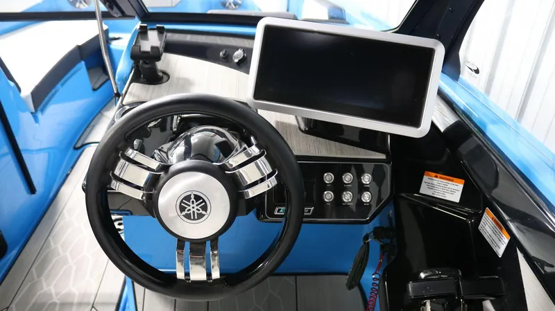 Slide: The Image of 2023 Yamaha Boats 222XD dashboard with steering wheel and touchscreen display. - 20