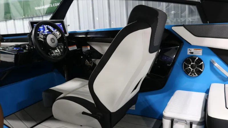 Slide: The Image of 2023 Yamaha Boats 222XD interior with modern steering and seating, featuring blue and white design. - 21