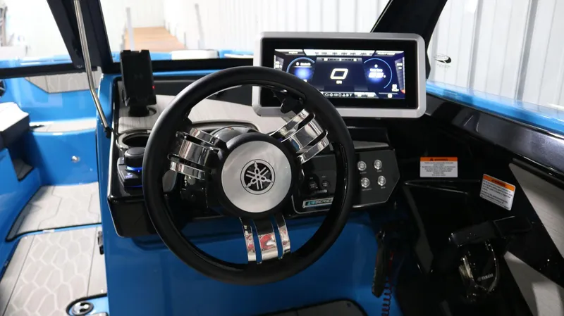 Slide: The Image of 2023 Yamaha Boats 222XD dashboard with steering wheel and digital display. - 22