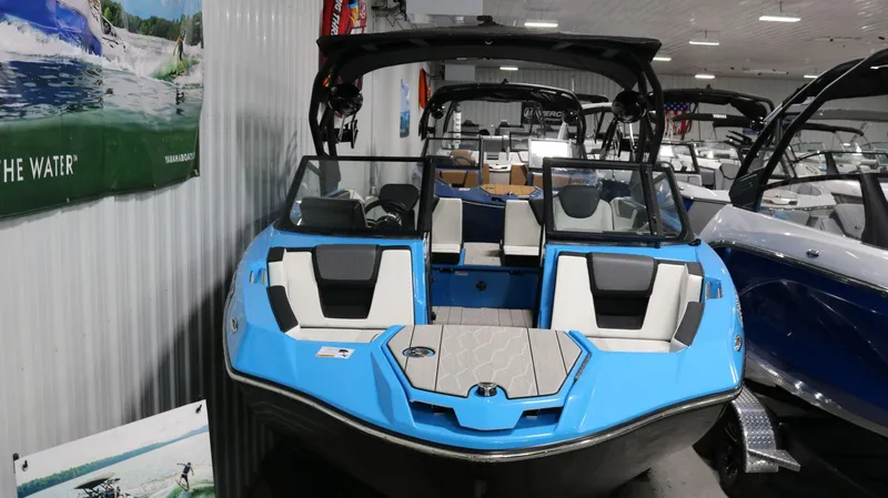 Slide: The Image of 2023 Yamaha Boats 222XD in showroom, featuring sleek blue design and modern interior. - 27