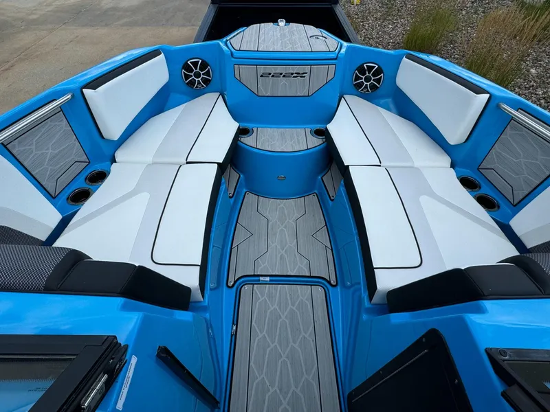 Slide: The Image of 2023 Yamaha Boats 222XD interior with blue and white seating, modern design, and cup holders. - 3