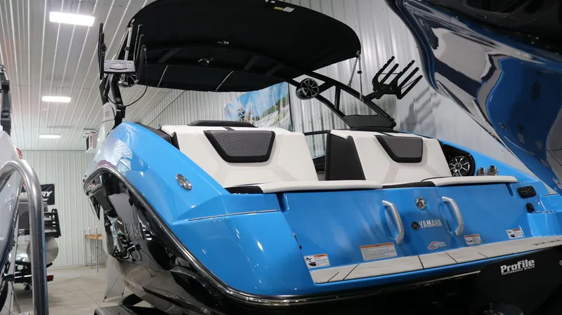 Slide: The Image of 2023 Yamaha Boats 222XD in showroom, featuring sleek blue and white design. - 31