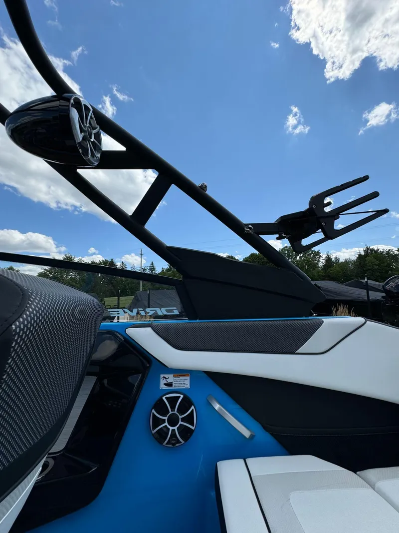 Slide: The Image of 2023 Yamaha Boats 222XD interior with speakers and seating, under a clear blue sky. - 32