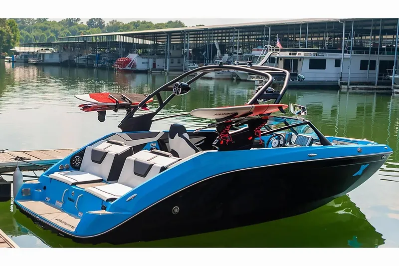 Slide: The Image of 2023 Yamaha Boats 222XD in marina, featuring sleek blue and black design. - 38