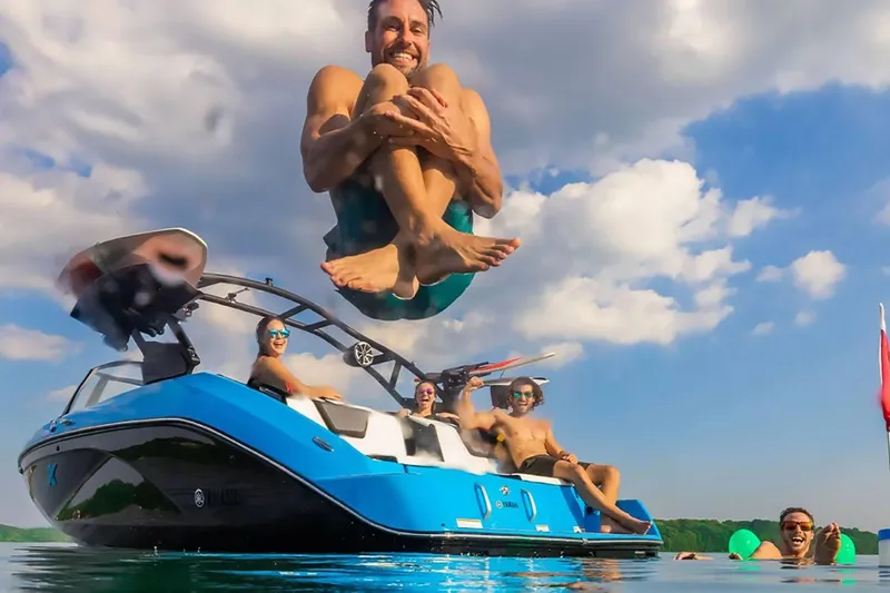 Slide: The Image of Man jumping off 2023 Yamaha Boats 222XD, friends enjoying on water. - 39