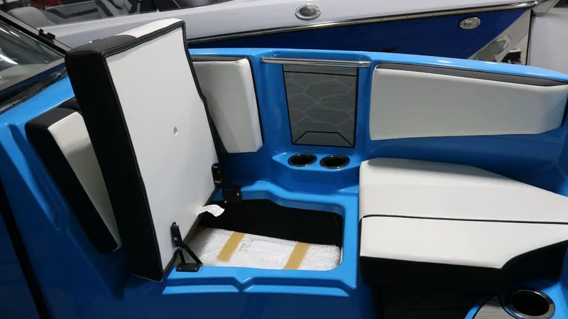 Slide: The Image of 2023 Yamaha Boats 222XD interior seating with storage compartment and cup holders. - 4