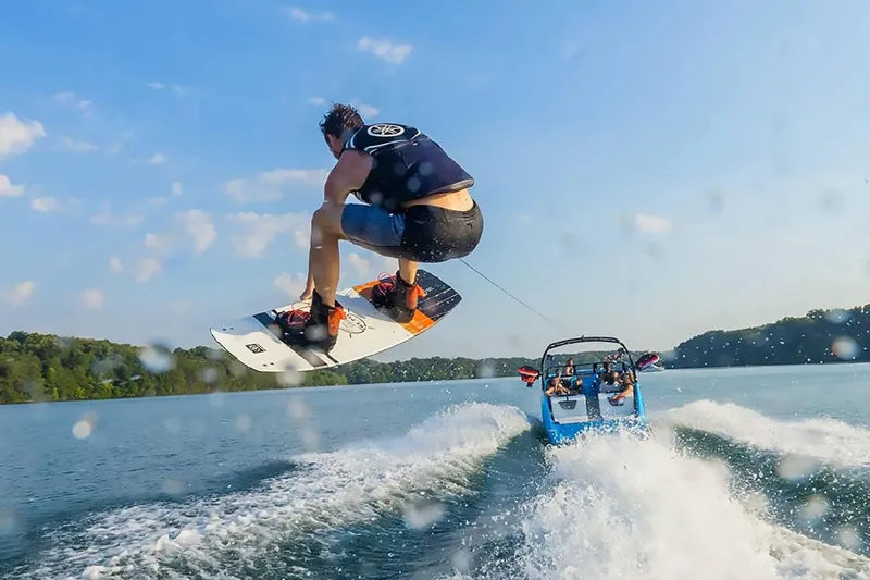 Slide: The Image of Wakeboarder jumps behind 2023 Yamaha Boats 222XD on a sunny lake. - 40