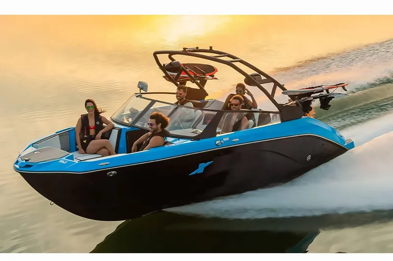 Slide: The Image of 2023 Yamaha Boats 222XD cruising on water at sunset with passengers. - 41