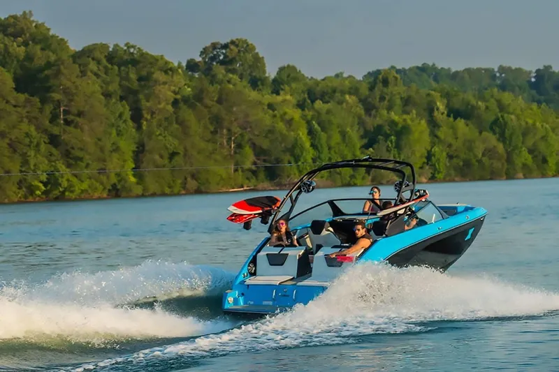Slide: The Image of 2023 Yamaha Boats 222XD cruising on a lake with passengers, surrounded by lush greenery. - 42