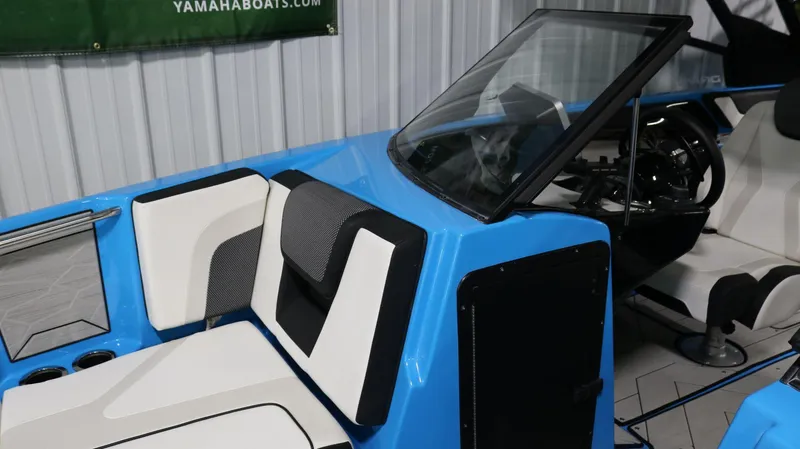 Slide: The Image of 2023 Yamaha Boats 222XD interior with blue and white seating, steering console, and windshield. - 8