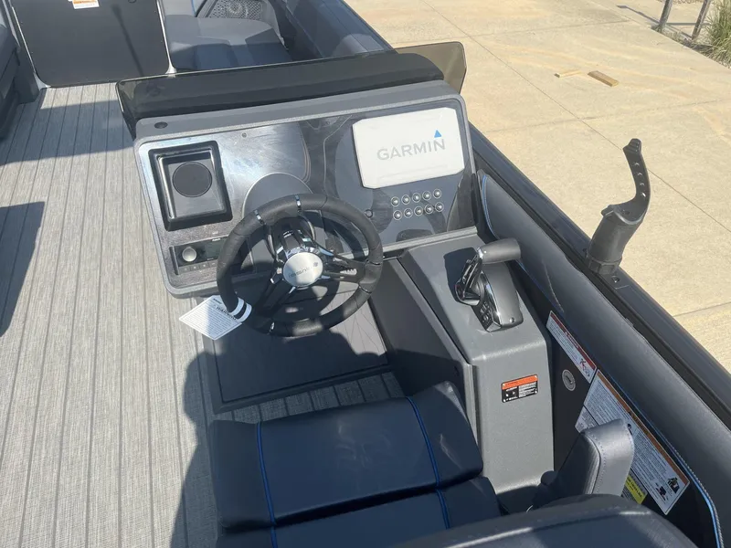 Slide: The Image of 2023 Manitou Explore 24 Switchback boat dashboard with Garmin navigation system. - 11