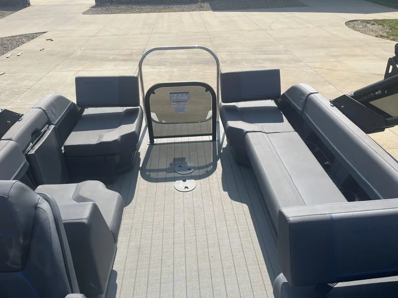 Slide: The Image of 2023 Manitou Explore 24 Switchback boat interior with spacious seating and modern design. - 8