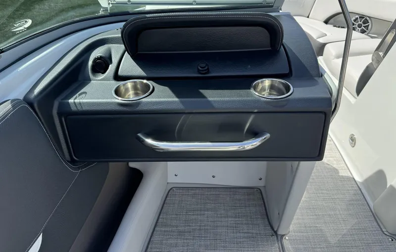 Slide: The Image of 2024 Crownline 240SS boat interior with cup holders and storage compartment. - 10