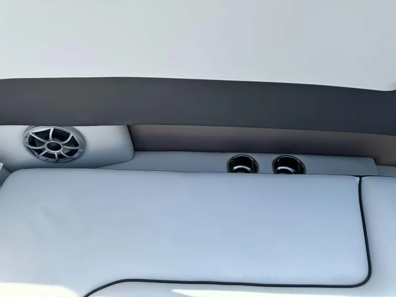 Slide: The Image of 2024 Crownline 240SS boat interior with speaker and cup holders. - 16