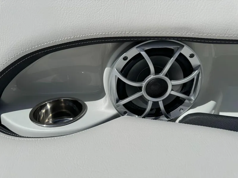 Slide: The Image of 2024 Crownline 240SS boat speaker and cup holder detail, white interior. - 17