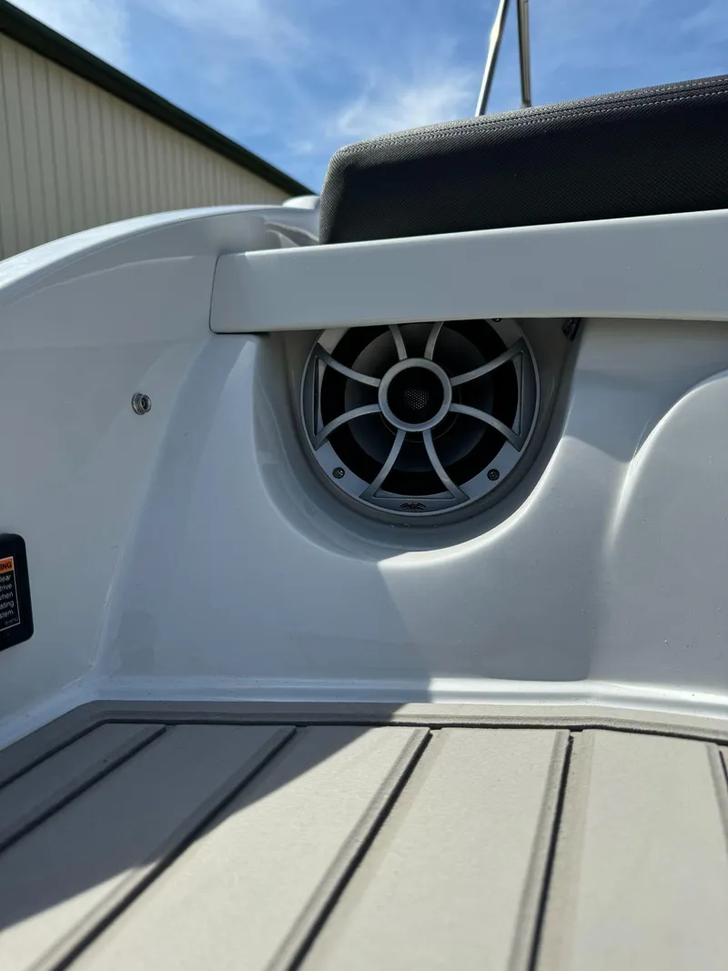 Slide: The Image of 2024 Crownline 240SS boat interior with speaker and cushioned seating. - 18