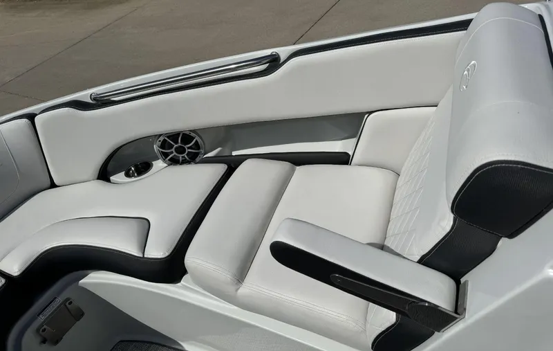 Slide: The Image of 2024 Crownline 240SS boat interior with white leather seating and speaker detail. - 19