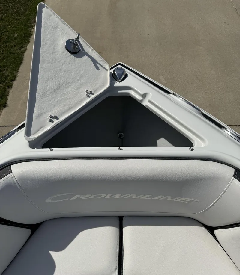 Slide: The Image of 2024 Crownline 240SS boat interior with open storage compartment. - 22