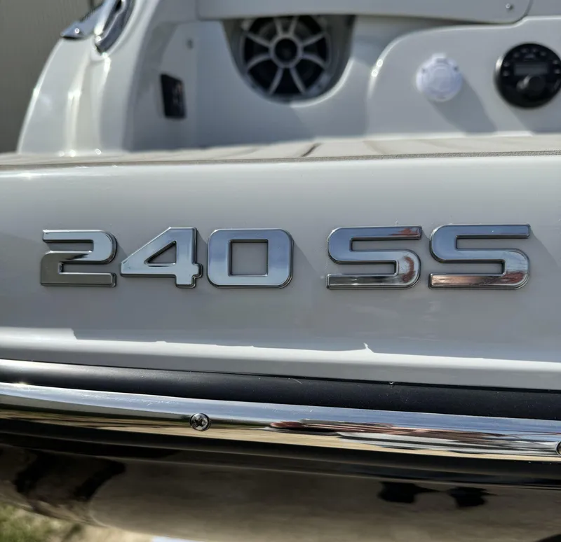 Slide: The Image of 2024 Crownline 240SS boat emblem close-up with sleek design details. - 26