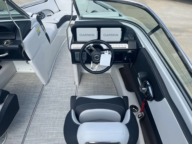 Slide: The Image of 2024 Crownline 240SS boat interior with Garmin navigation system and modern steering wheel. - 8