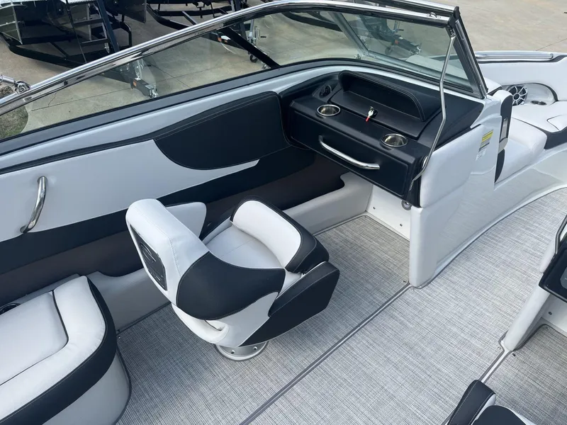 Slide: The Image of 2024 Crownline 240SS boat interior with sleek seating and modern dashboard. - 9