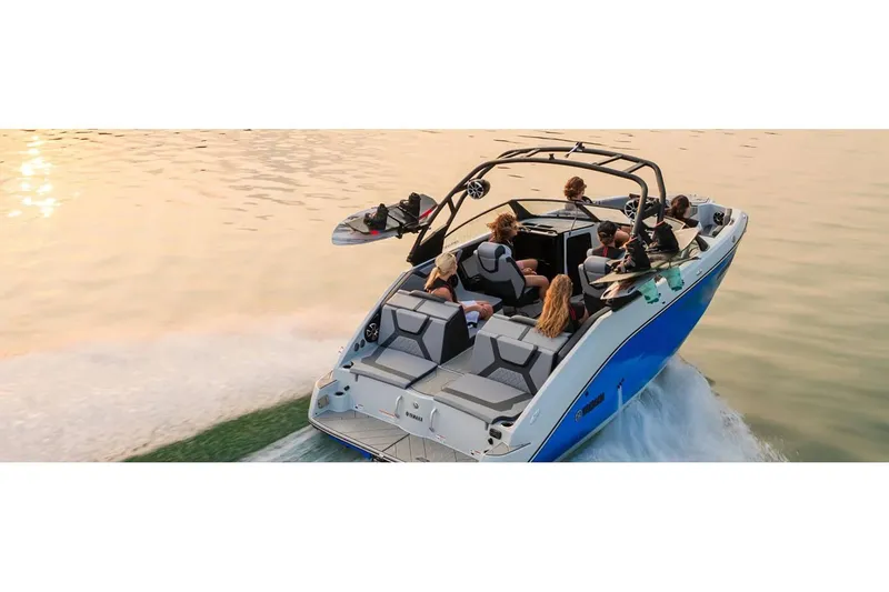 Slide: The Image of 2024 Yamaha Boats 222XE cruising on a serene lake at sunset. - 14