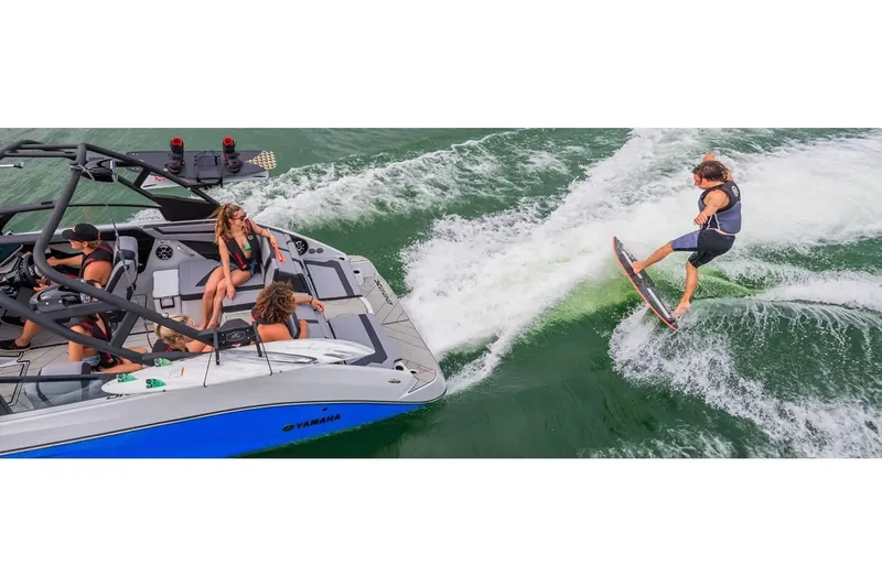Slide: The Image of 2024 Yamaha Boats 222XE with wakeboarder, vibrant water activity scene. - 15