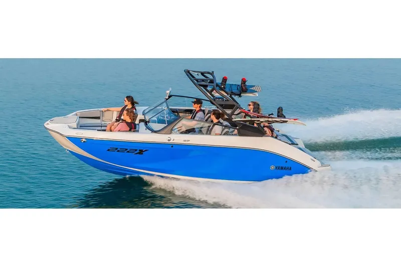 Slide: The Image of 2024 Yamaha Boats 222XE speeding on water with passengers enjoying the ride. - 17