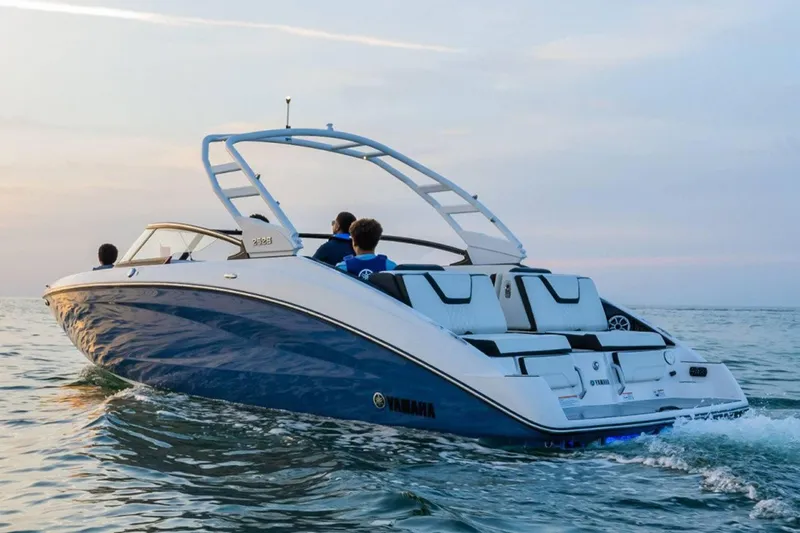 Slide: The Image of 2024 Yamaha Boats 252S cruising on open water at sunset. - 16