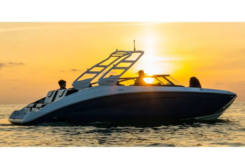 Slide: The Image of 2024 Yamaha Boats 252S cruising at sunset with passengers on board. - 19